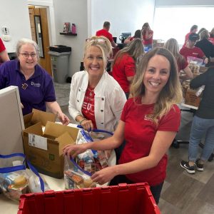 KW Greater 360 Agents packing food for StandUp For Kids Kitsap
