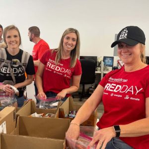 KW Greater 360 Agents packing food for StandUp For Kids Kitsap