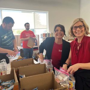 KW Greater 360 Agents packing food for StandUp For Kids Kitsap