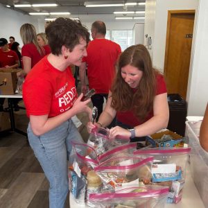 KW Greater 360 Agents packing food for StandUp For Kids Kitsap