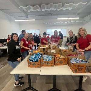 KW Greater 360 Agents packing food for StandUp For Kids Kitsap
