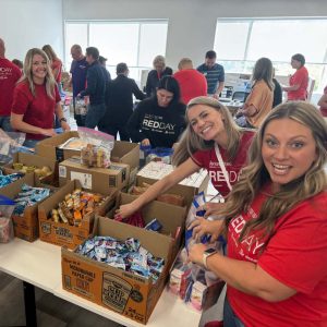 KW Greater 360 Agents packing food for StandUp For Kids Kitsap