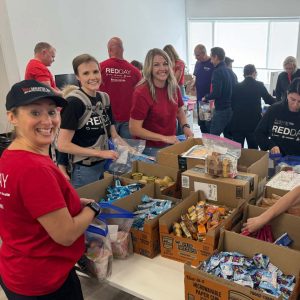 KW Greater 360 Agents packing food for StandUp For Kids Kitsap